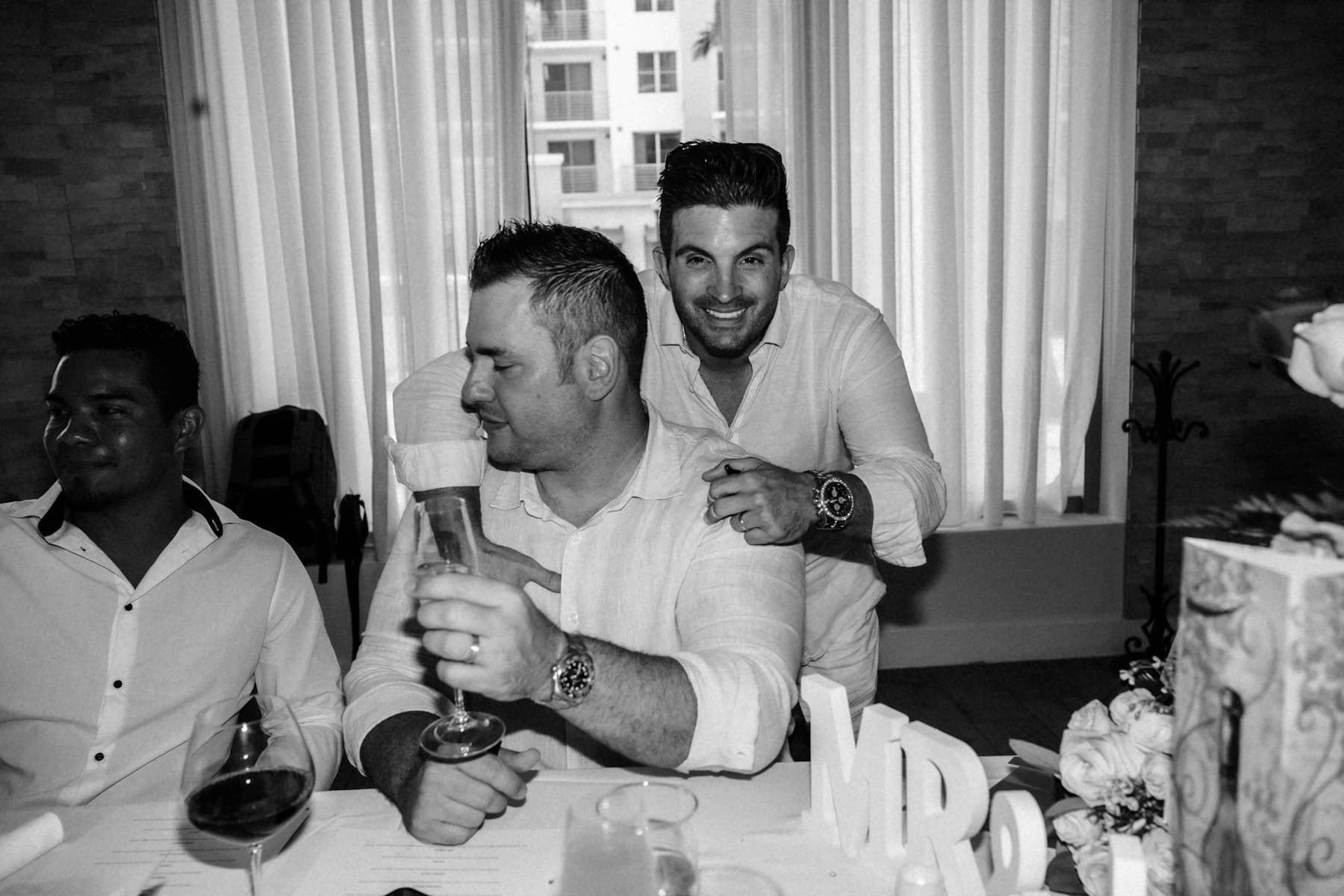 Wedding guests raising a toast at a reception branded by their planner