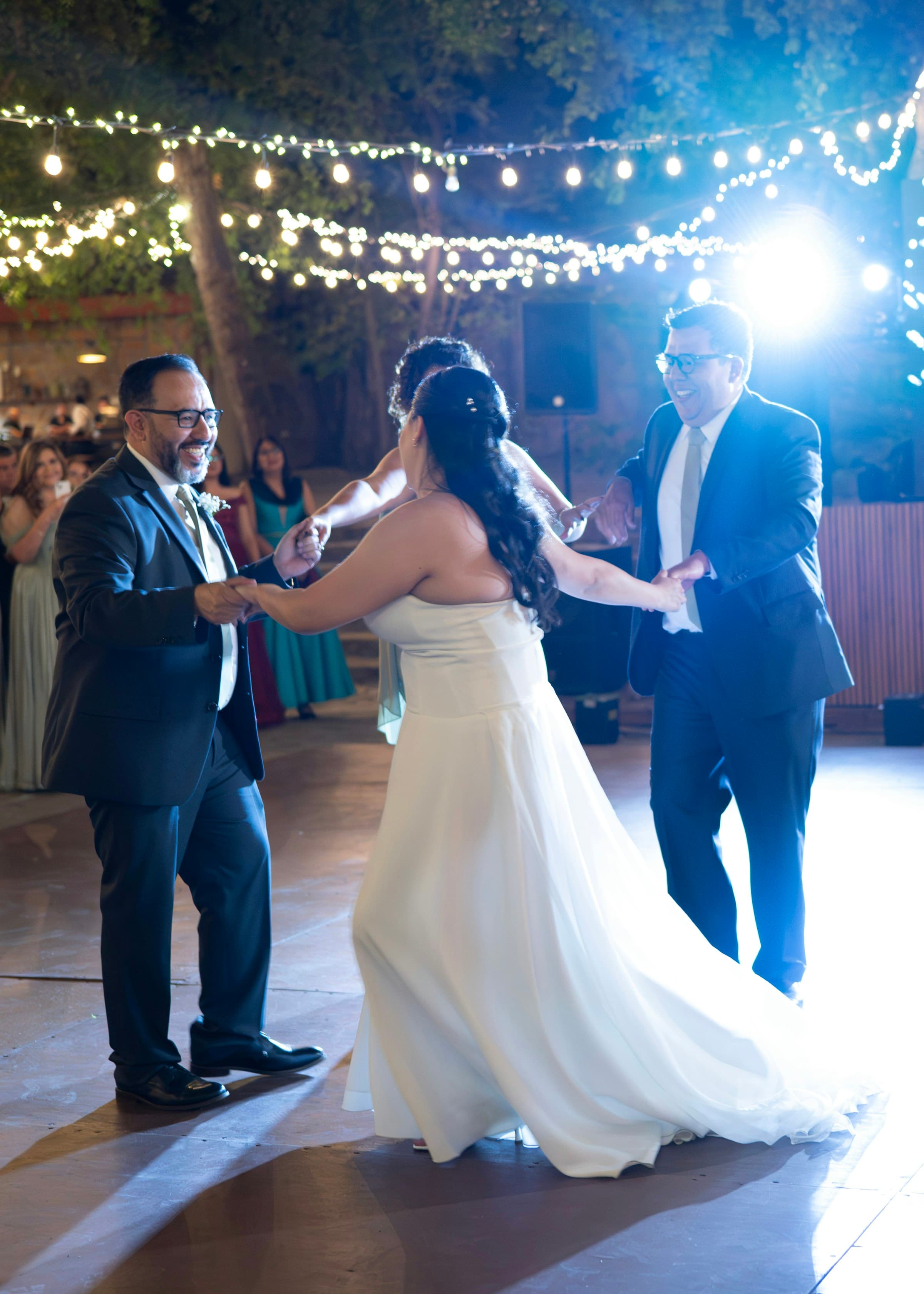 A couple at a candlelit reception, with film-camera filters cycling on the Gooya guest camera